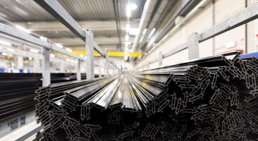 Black thermal strips stacked in iron chassis in warehouse.