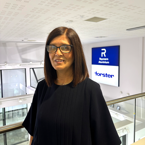 A woman standing in front of a showroom