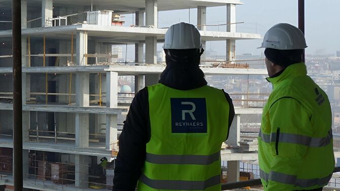  Construction professionals looking out on building project.