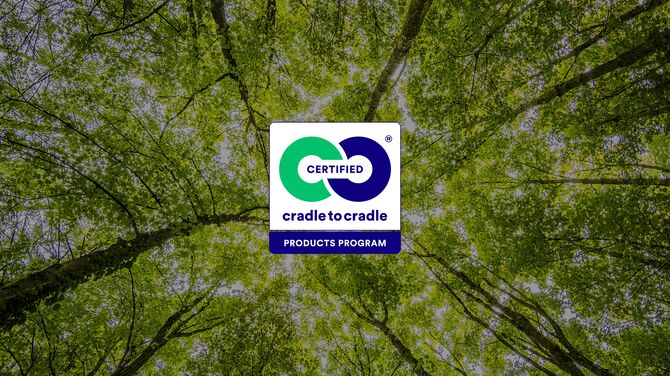 Cradle to Cradle logo in front of green tree tops.