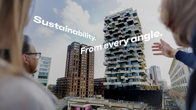 Man and woman pointing at green building in Eindhoven.