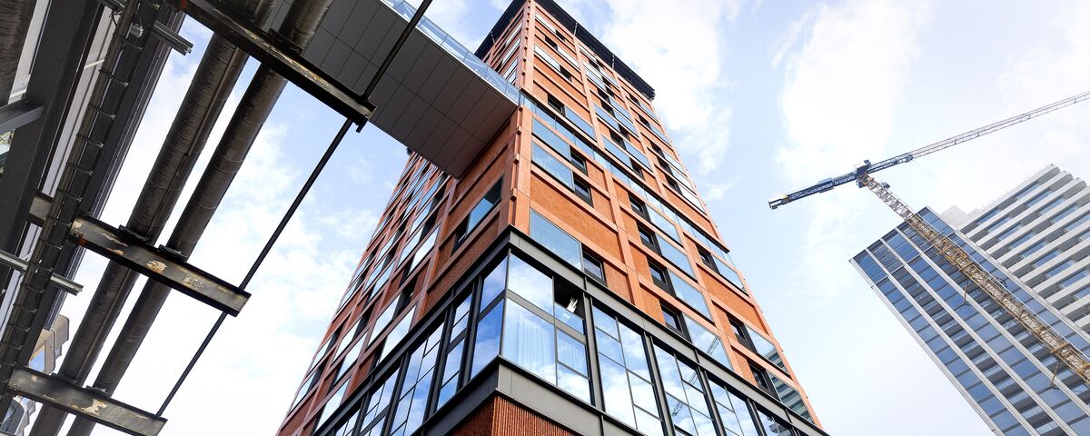 Angled view of orange high-rise building.