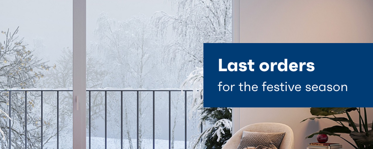 A balcony door outlooking a wintery scene, with an armchair next to it.