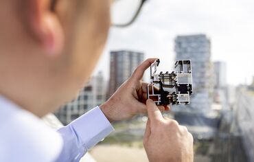 Man holding and pointing at aluminium section sample.